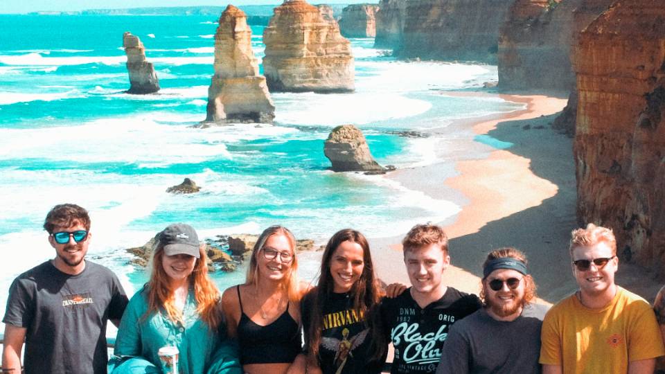 Group standing in front of the 12 Apostles along the Great Ocean Road