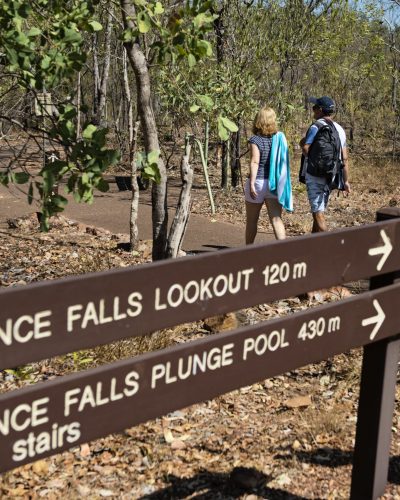 Visitors walking to Florence Falls.Get set for real adventure and to connect with nature at Litchfield National Park. At just over an hour from Darwin, it's every local's favourite day trip with its waterfalls and water holes, bush walks, four-wheel drive tracks, birds and wildlife.